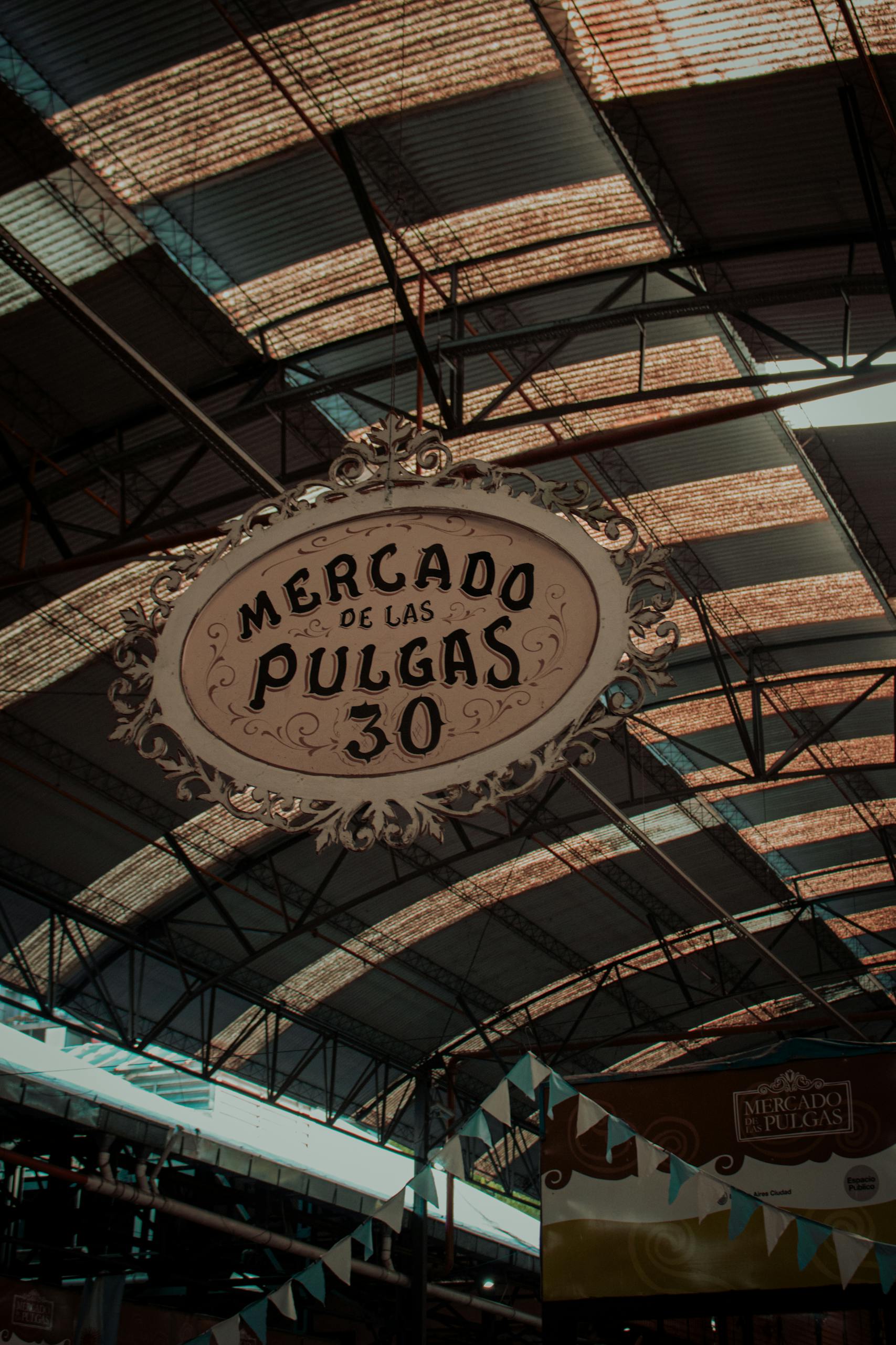 Vintage Mercado de las Pulgas sign in Buenos Aires market setting.